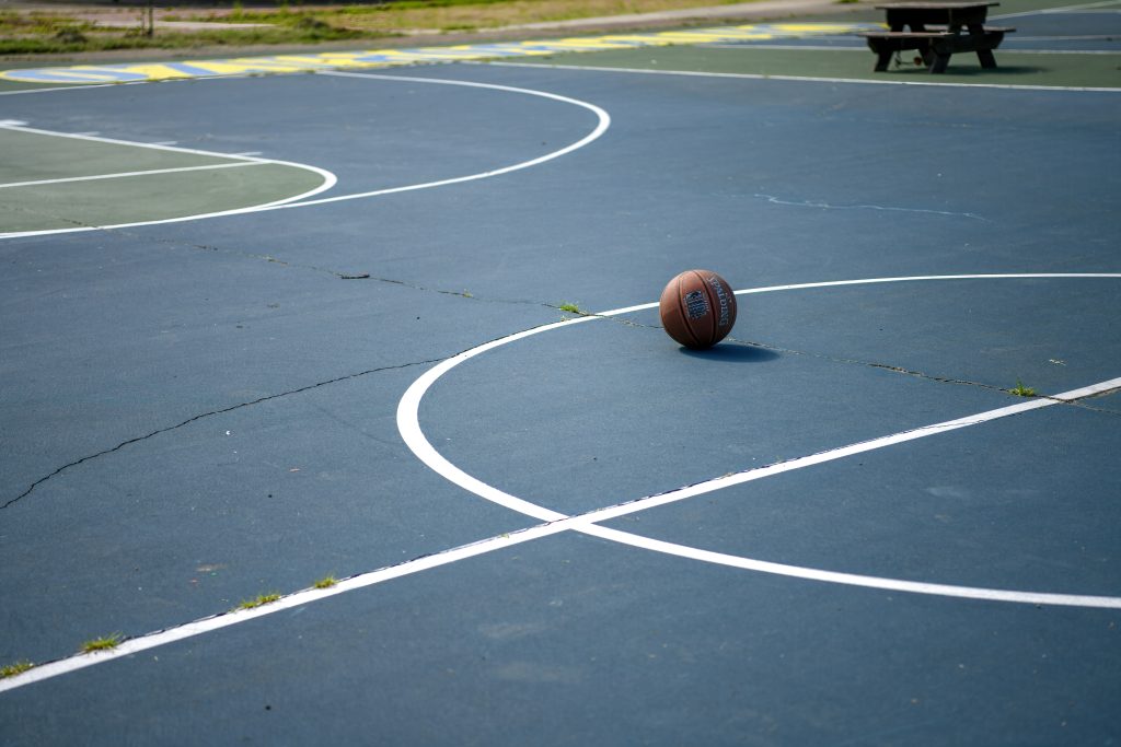 Basketball resting on an outdoor court