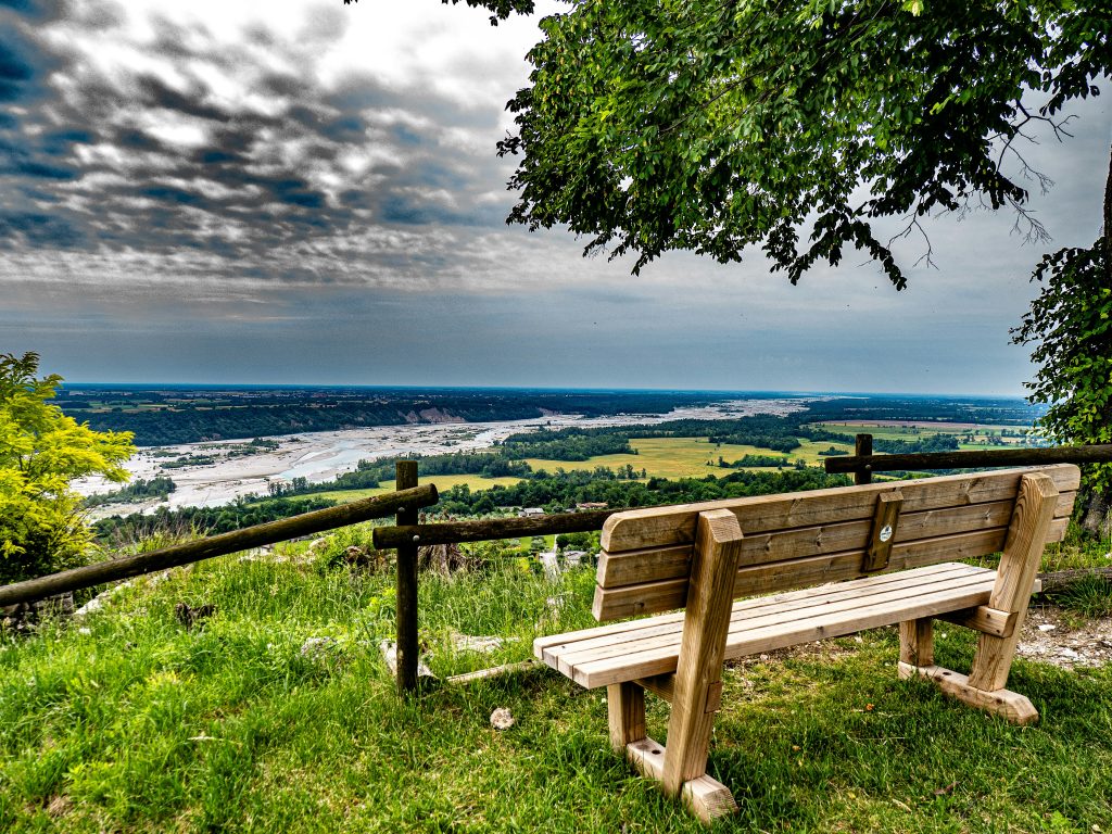 Park path and viewpoint overlooking a broad river landscape