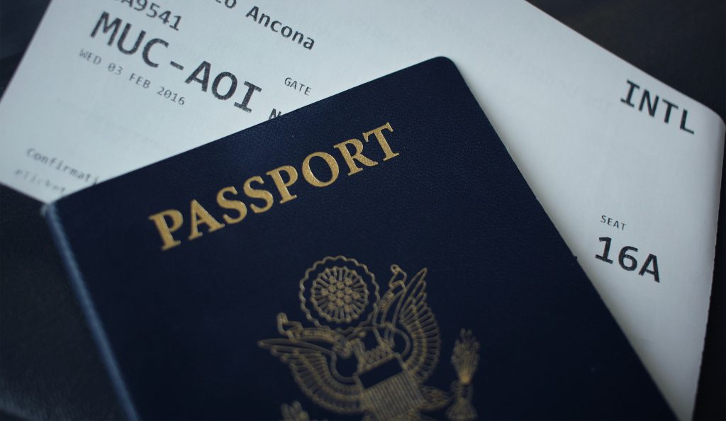 Passport resting on application paperwork, illustrative image for immigration-representative rules