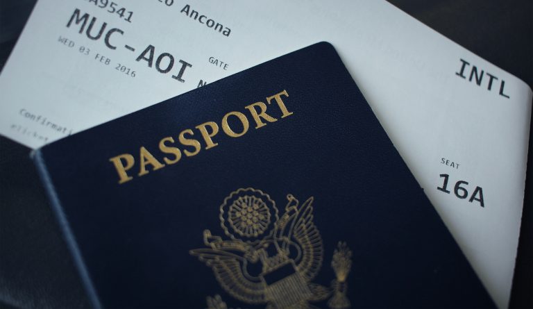 Passport resting on application paperwork, illustrative image for immigration-representative rules