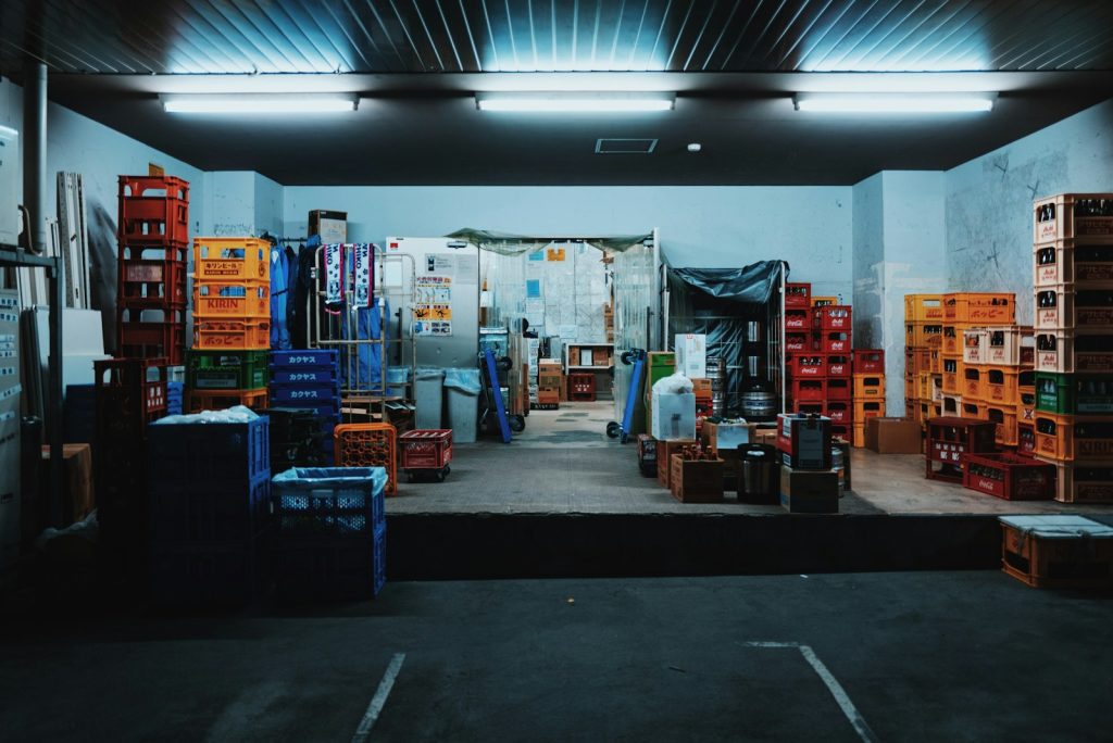 Stacked produce crates in a storage and distribution space, illustrative stock image