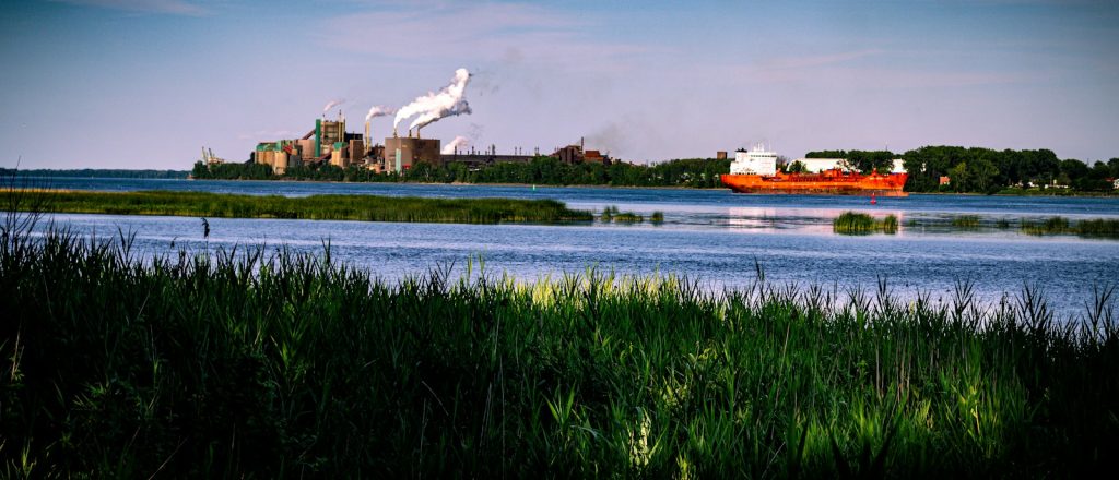 Industrial facility and cargo ship beside the St. Lawrence River in Quebec