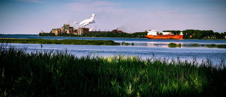 Industrial facility and cargo ship beside the St. Lawrence River in Quebec