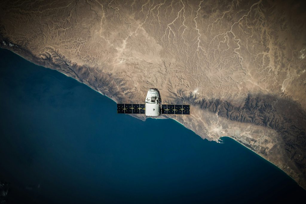 Satellite orbiting above a coastline viewed from space