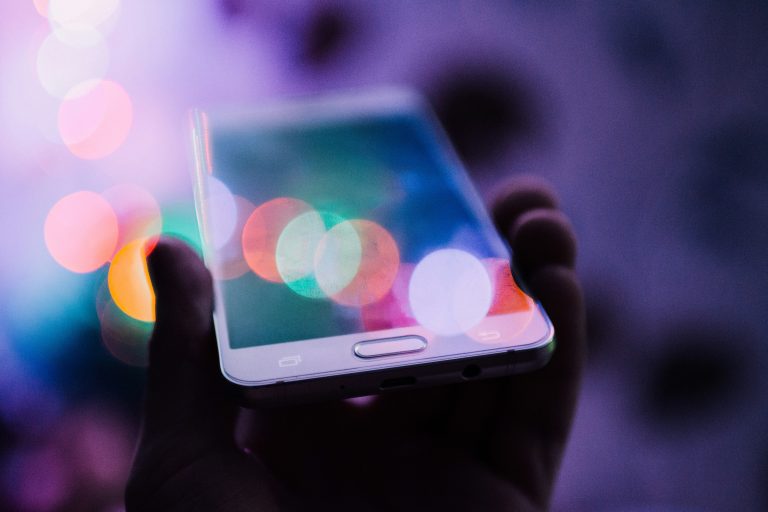 Person holding and using a smartphone, illustrative image for wireless-plan marketing