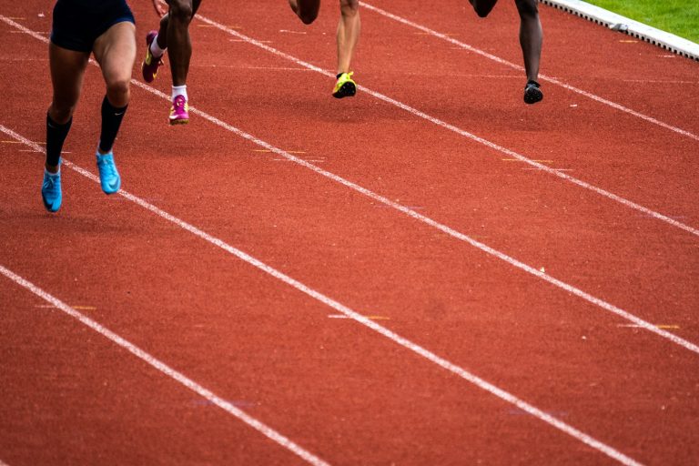 Athletes running on a track, illustrating Canadian sport integrity funding