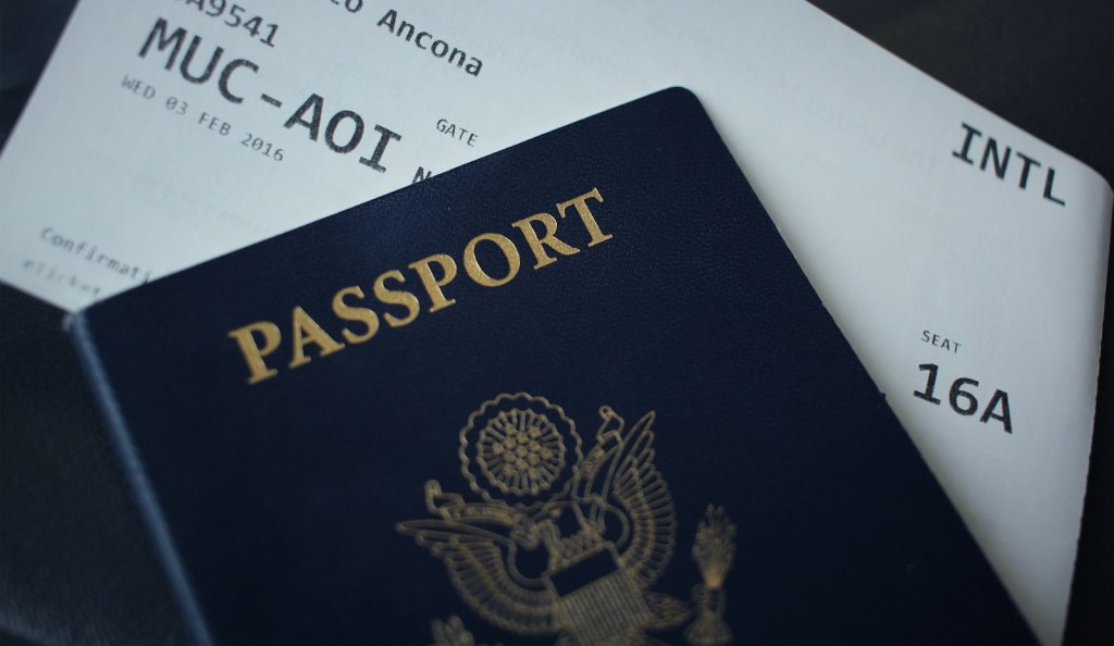 A passport booklet resting on travel documents
