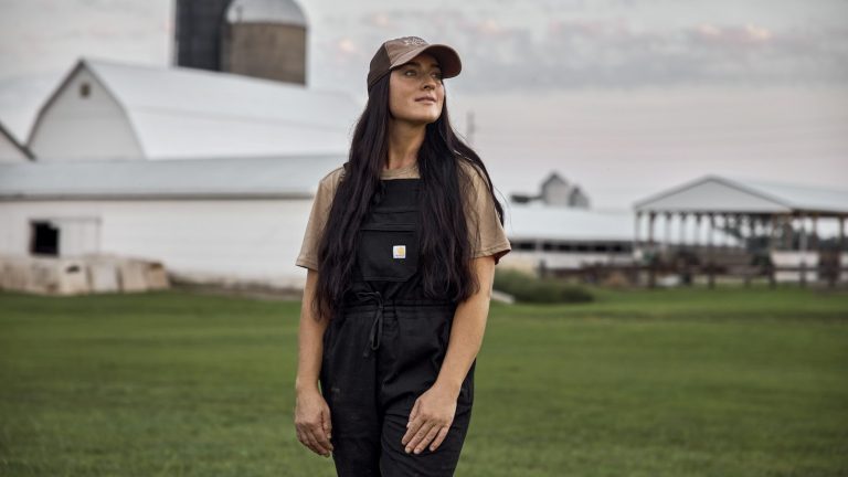Woman farmer standing outside a dairy barn