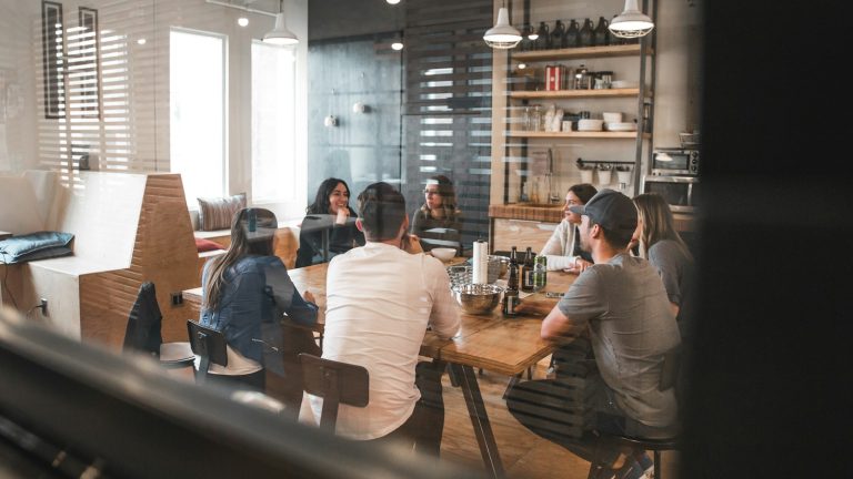 A group of people meeting around a table in a workplace, illustrative image